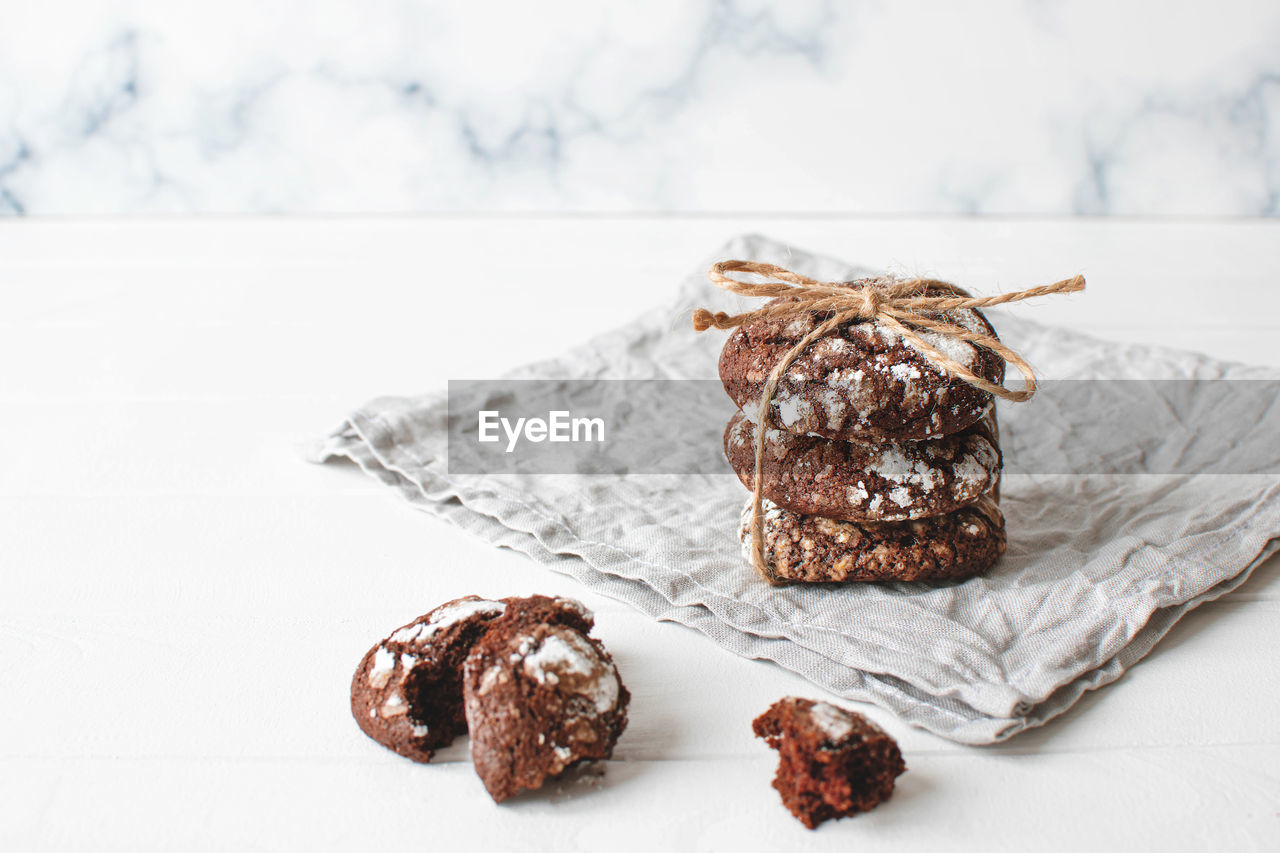 Freshly baked chocolate cookies on gray napkin over marble background..copy space.