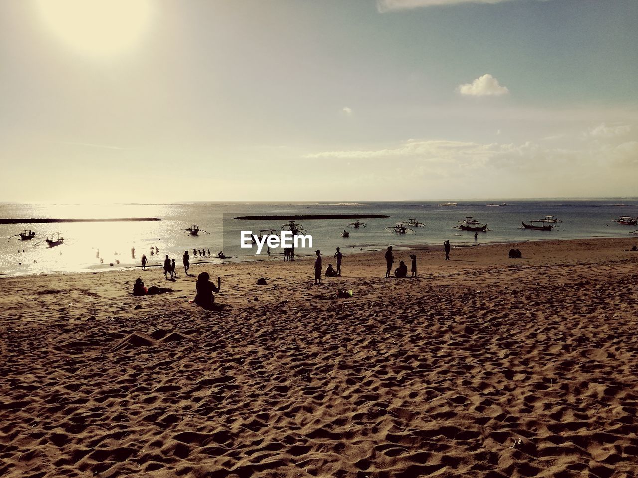 PEOPLE ENJOYING ON BEACH AGAINST SKY