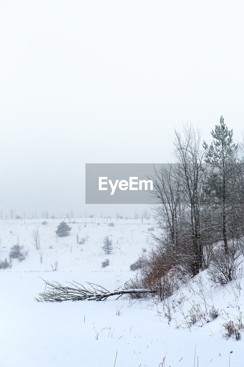 SNOW COVERED LAND AGAINST SKY