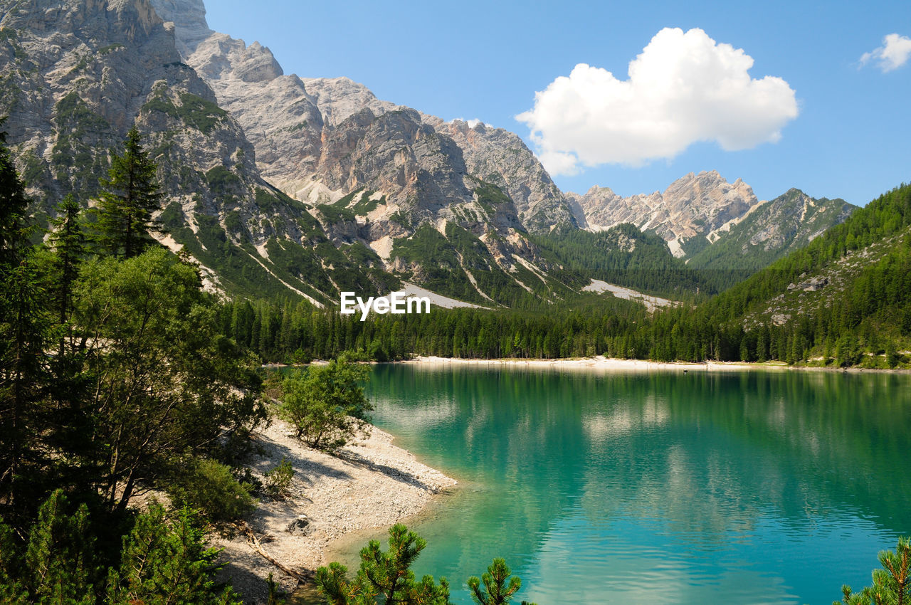 Scenic view of lake by mountains against sky