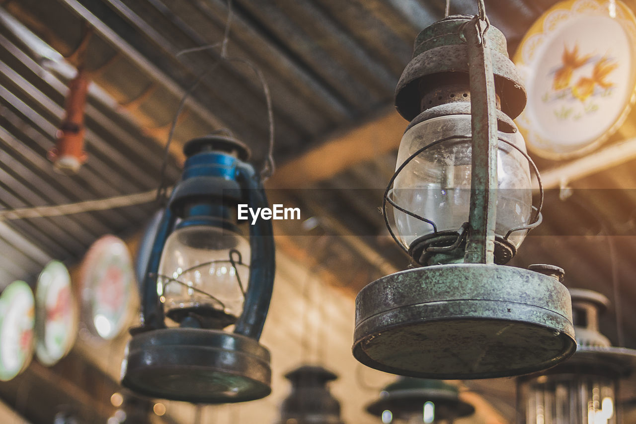 Low angle view of old lanterns hanging from ceiling