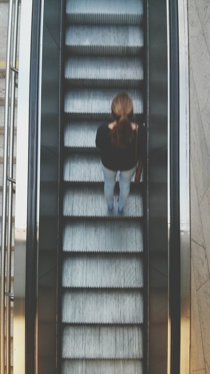 High angle view of woman on escalator