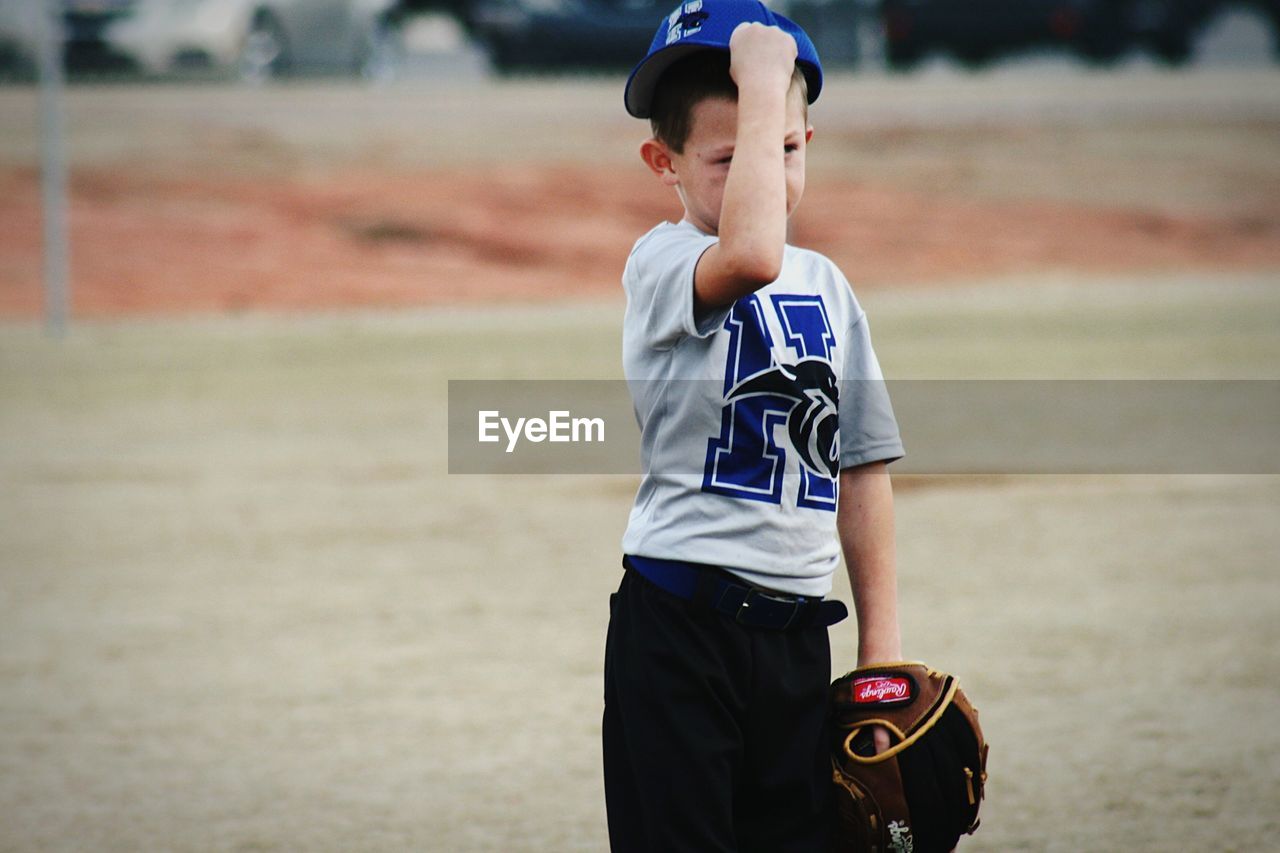 BOY WITH ARMS RAISED IN BACKGROUND