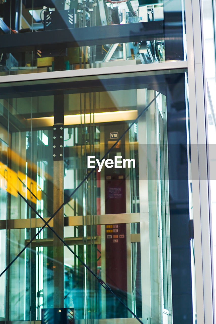 LOW ANGLE VIEW OF MODERN GLASS BUILDING