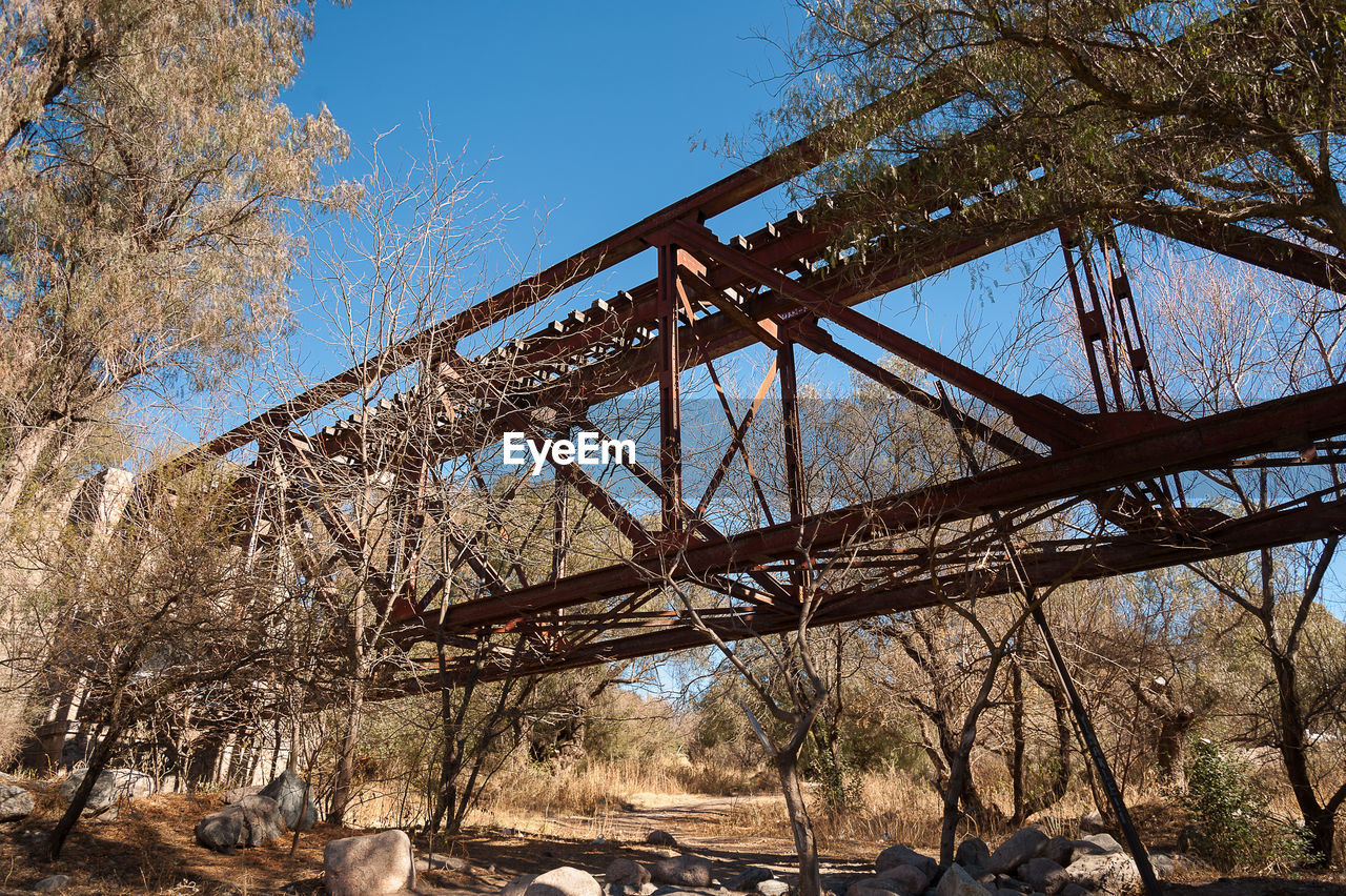 Low angle view of abandoned railway bridge on field