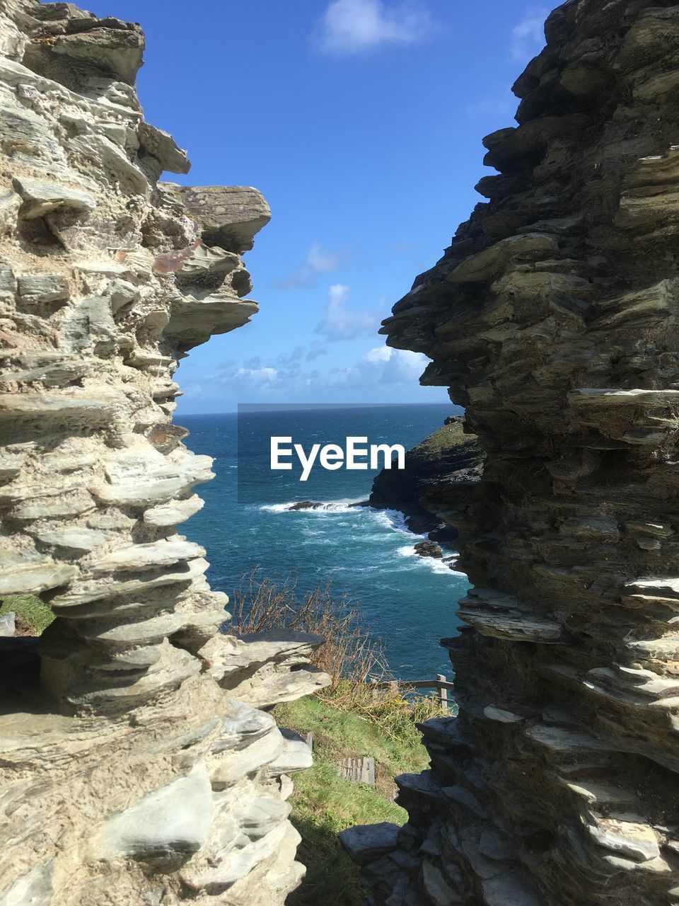 Scenic view of rocks on beach against sky