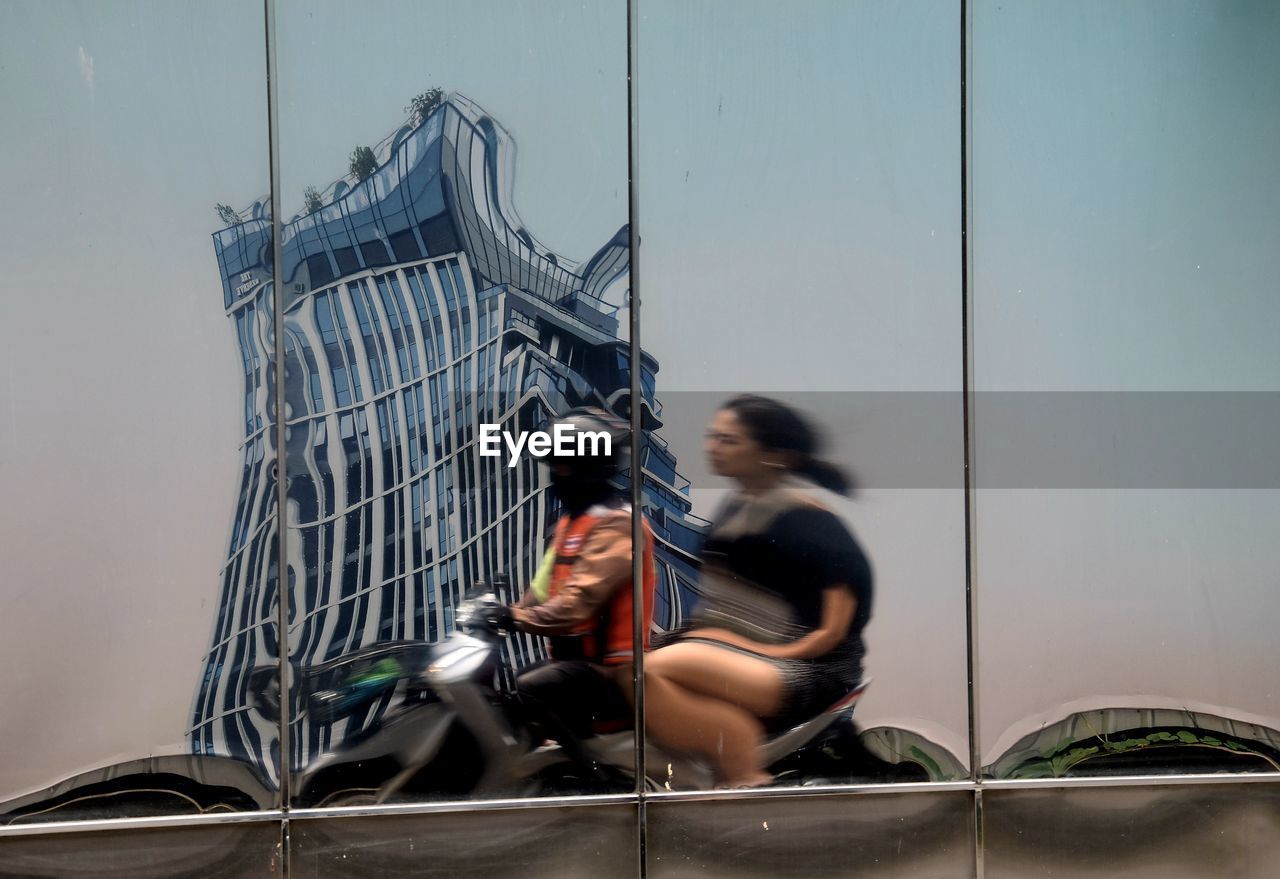 adult, two people, women, sitting, architecture, full length, men, young adult, togetherness, lifestyles, nature, casual clothing, transportation, female, day, built structure, outdoors, leisure activity, sky, emotion, activity, friendship