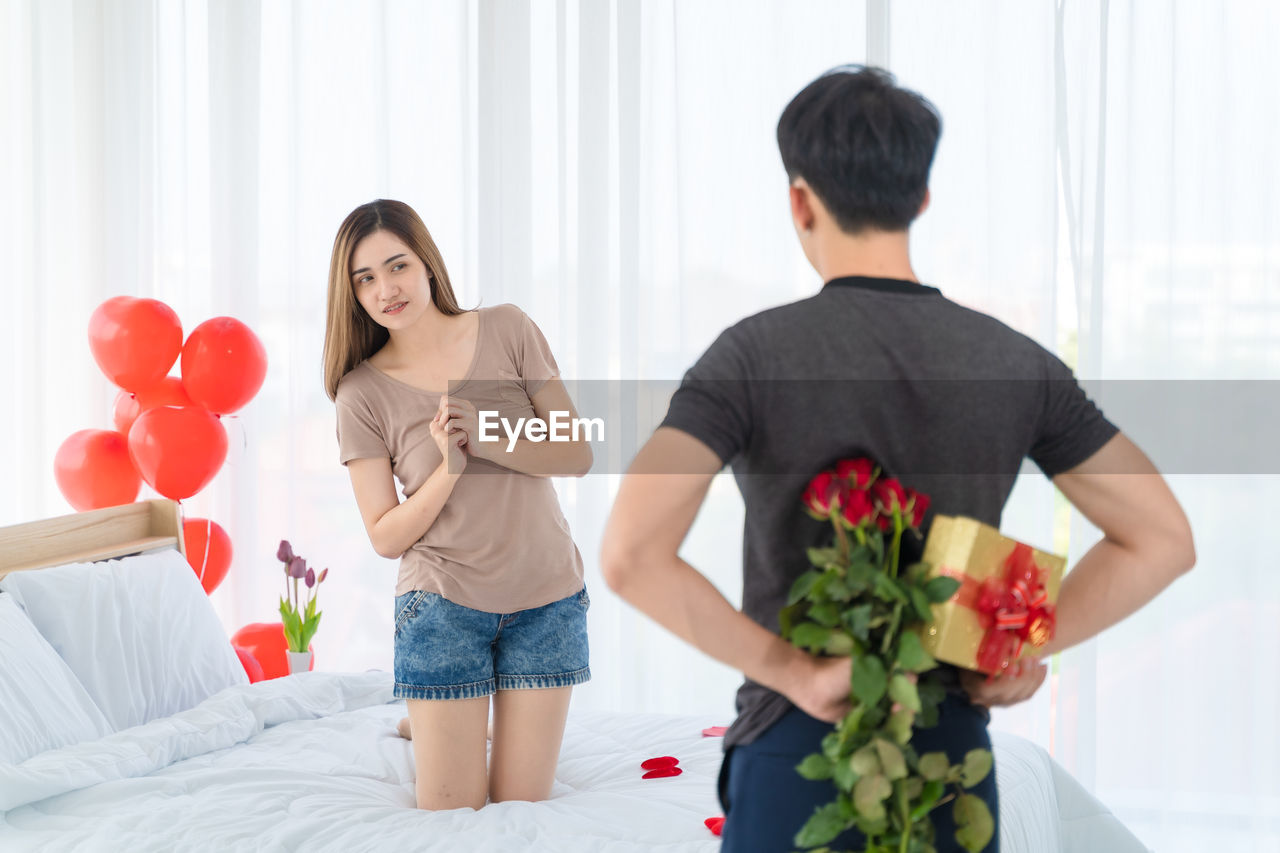COUPLE STANDING IN FRONT OF TWO PEOPLE AT RED BALLOONS
