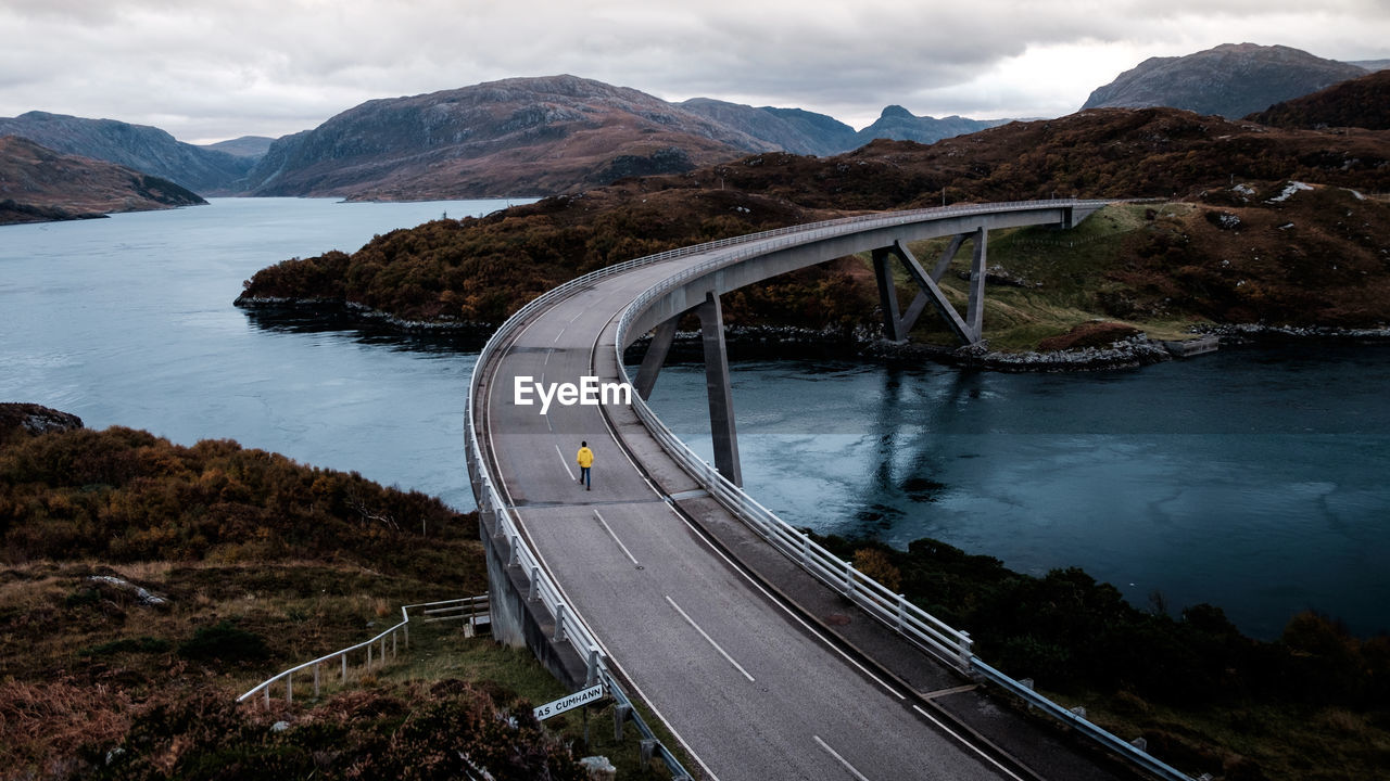 View of bridge over river against cloudy sky