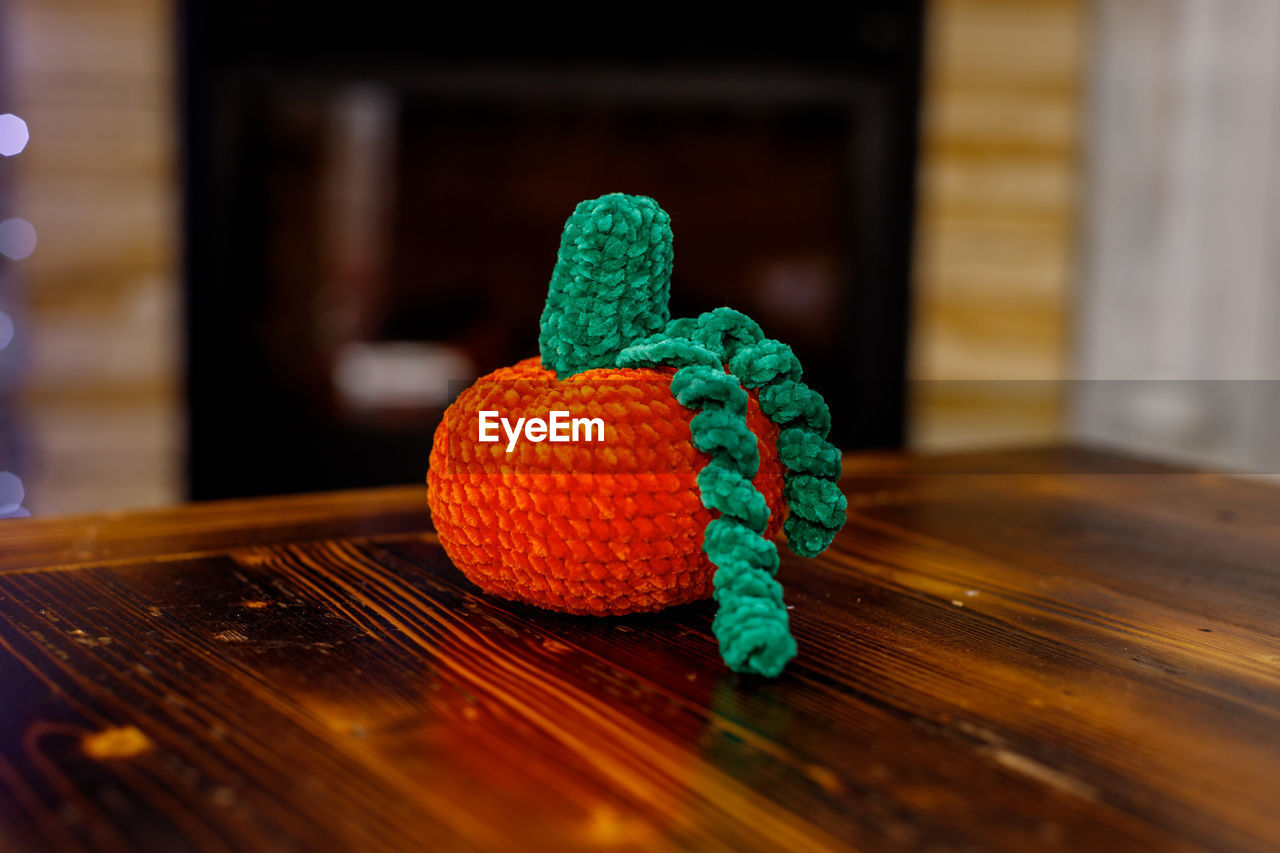 wood, indoors, table, no people, craft, art, green, yellow, wool, focus on foreground, toy, red, creativity, food and drink, representation, selective focus, close-up, crochet, still life, food, decoration, blue