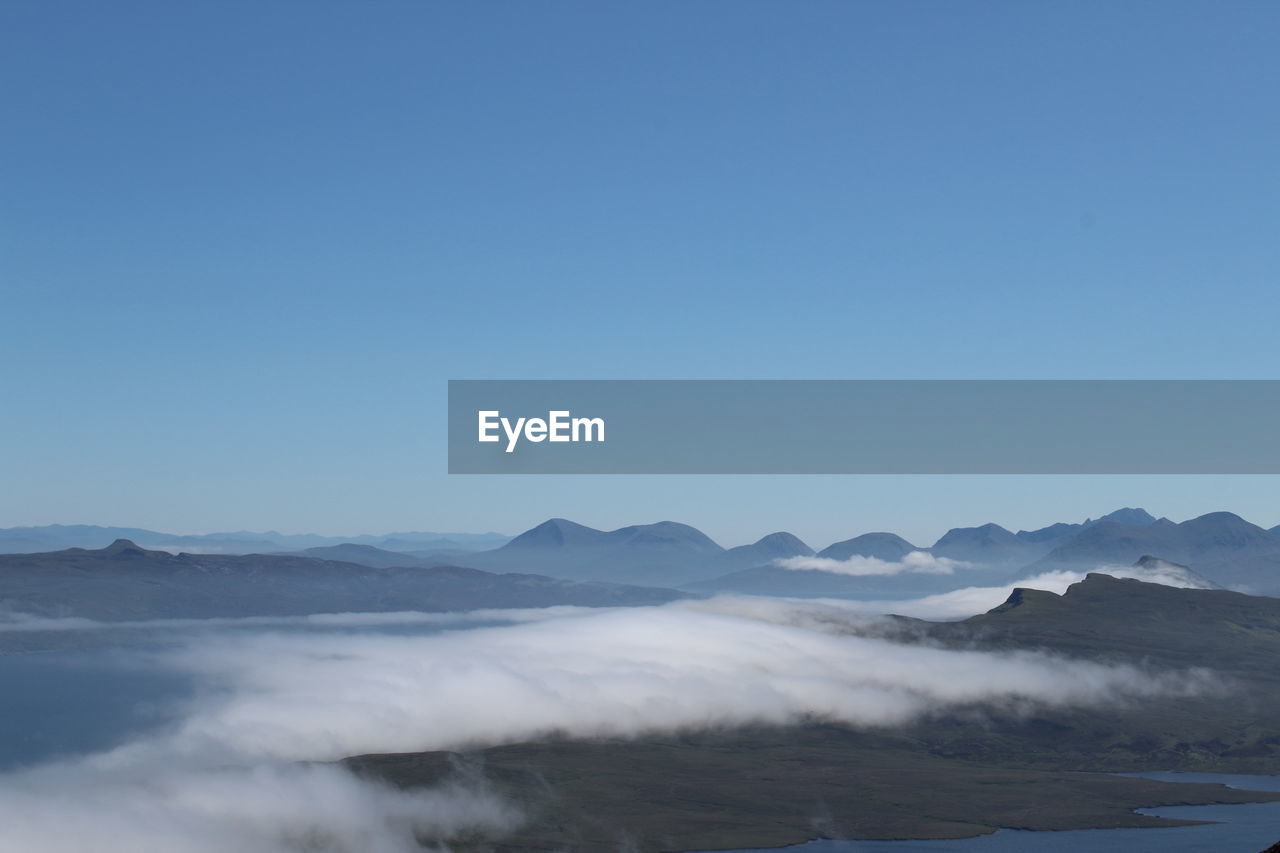 Scenic view of mountains against clear blue sky