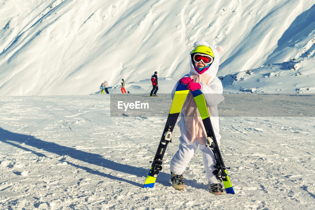 Girl skiing on snow covered mountain