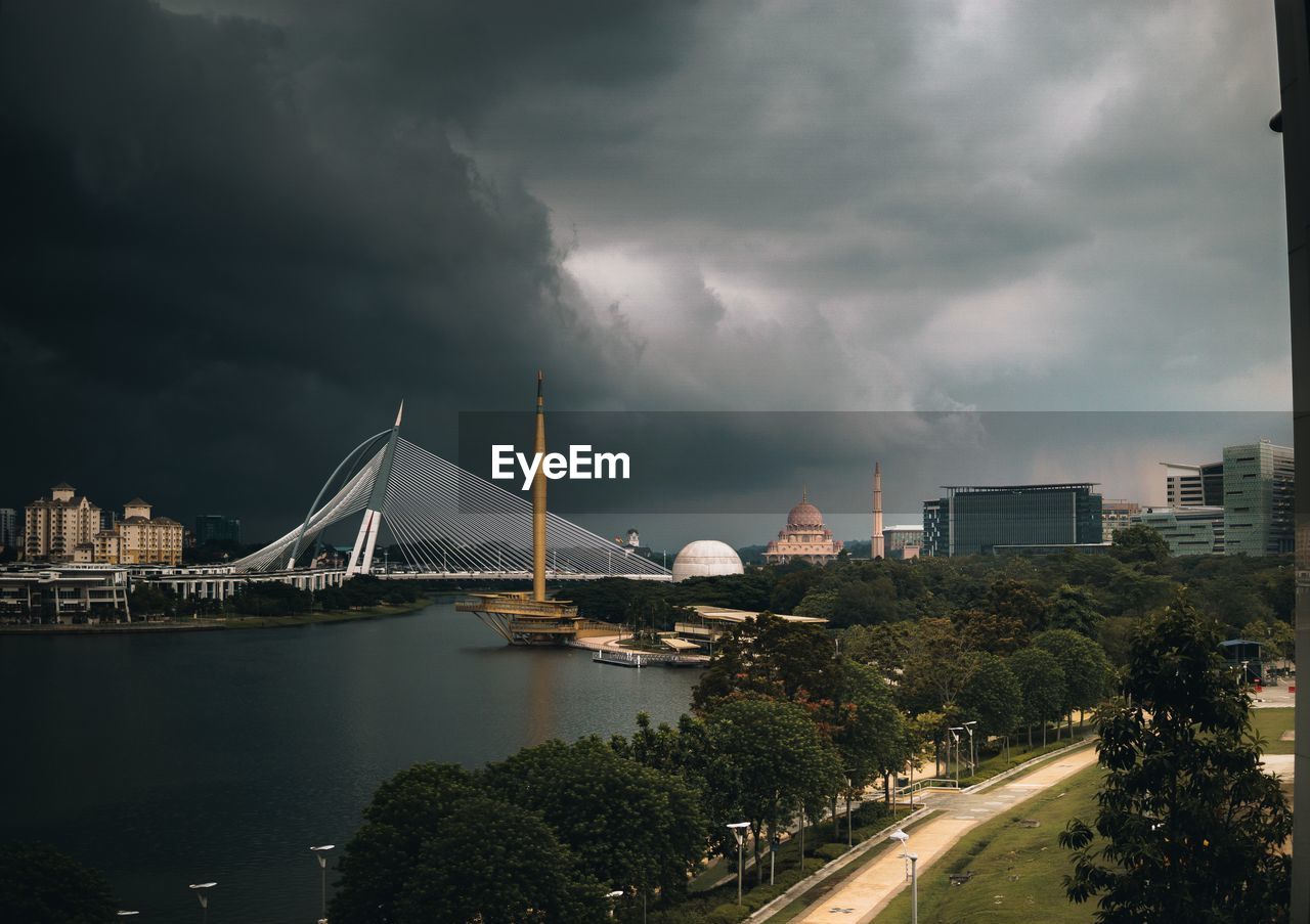 VIEW OF BRIDGE OVER RIVER AGAINST CLOUDY SKY