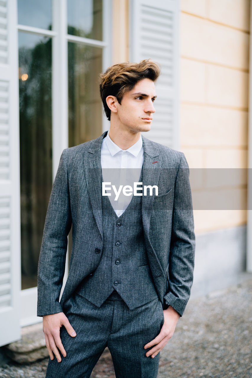 YOUNG MAN LOOKING AWAY OUTDOORS