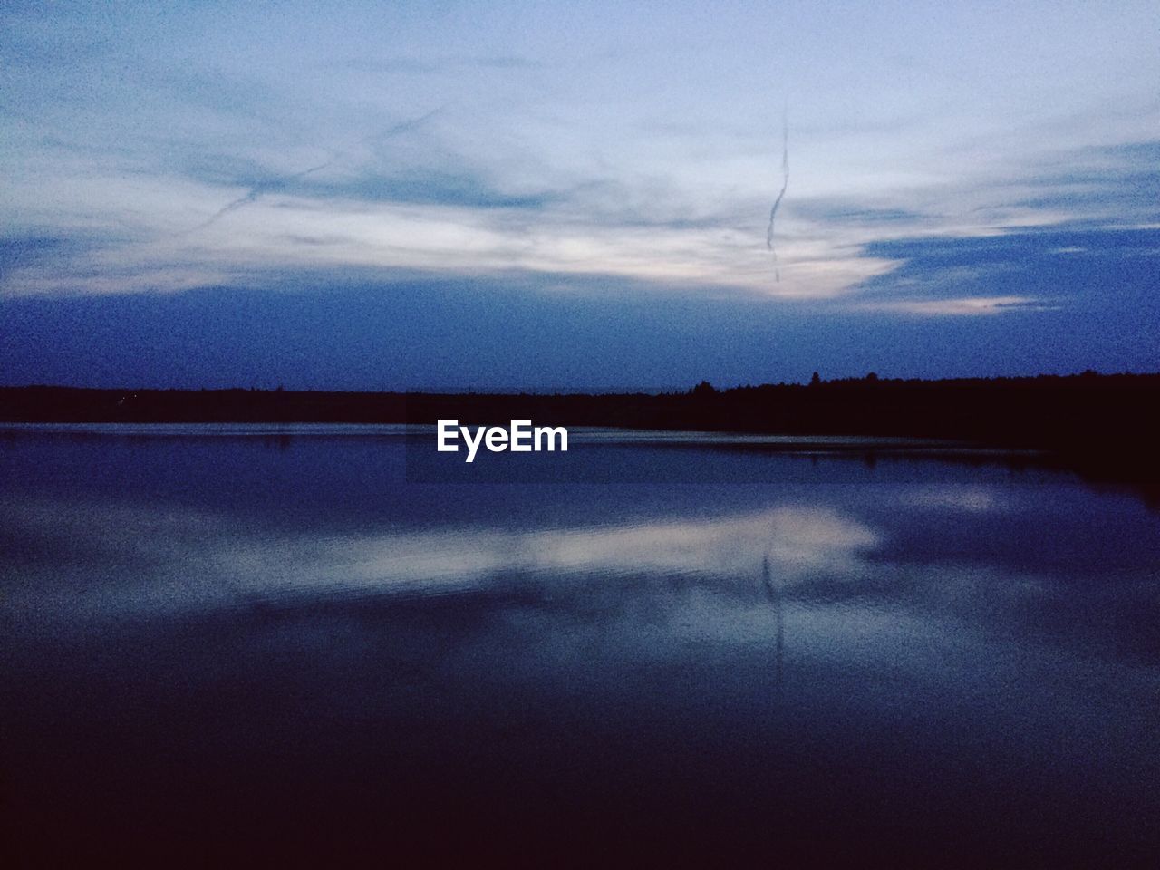 REFLECTION OF SKY IN LAKE