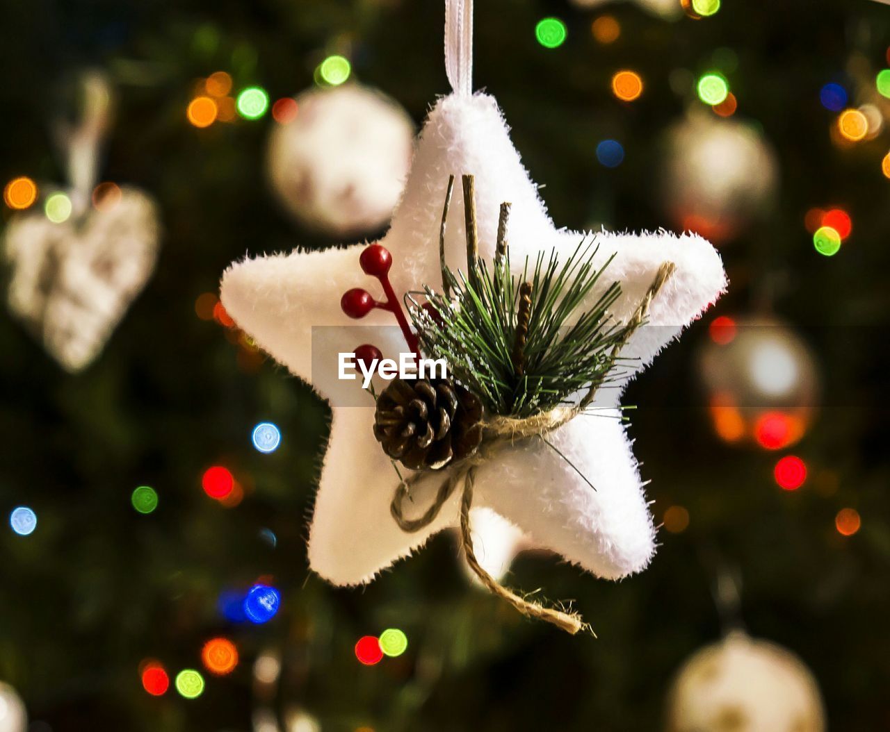 Close-up of star shape decoration hanging on christmas tree