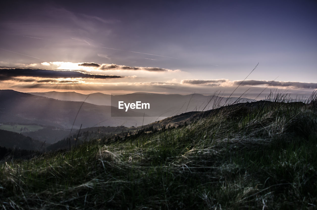 SCENIC VIEW OF MOUNTAINS AGAINST SKY DURING SUNSET