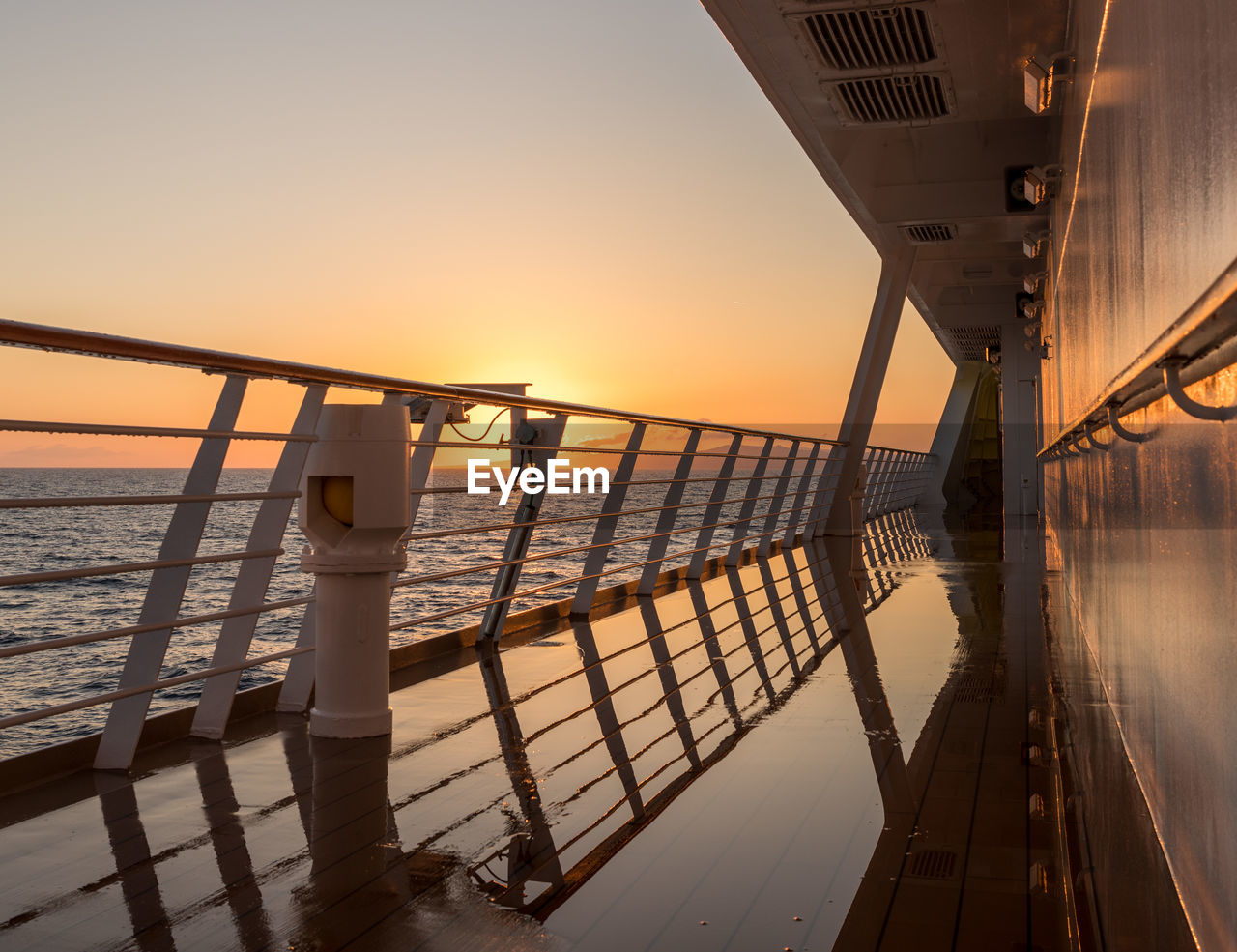 PIER OVER SEA AGAINST ORANGE SKY