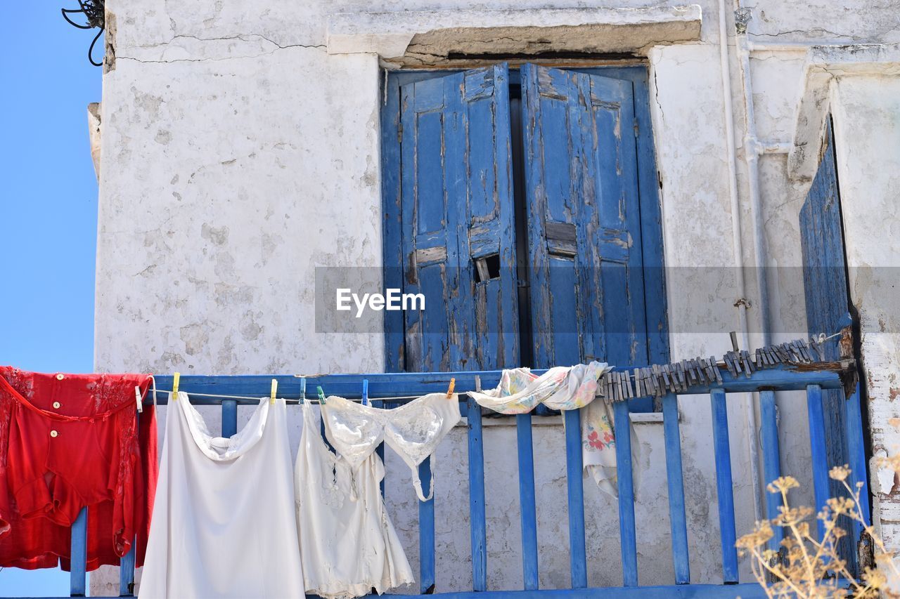 Clothes drying against blue wall of building,mykonos, greece 