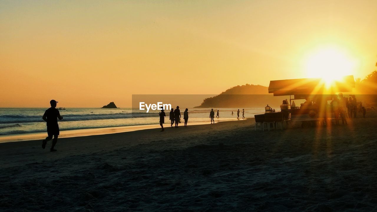 PEOPLE AT BEACH DURING SUNSET