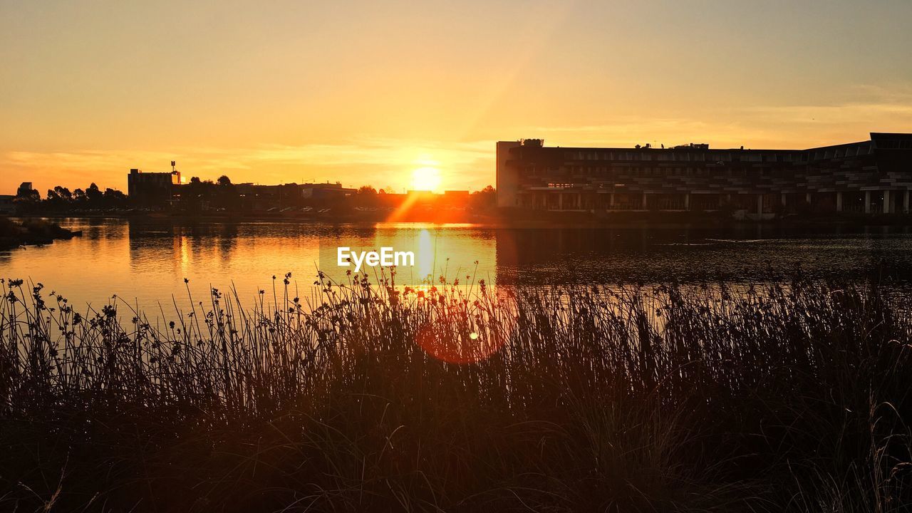 Scenic view of lake against sky during sunset