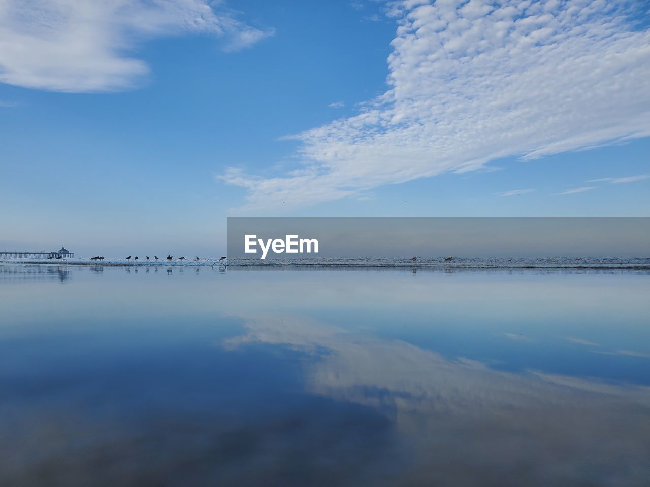 Scenic view of sea against blue sky