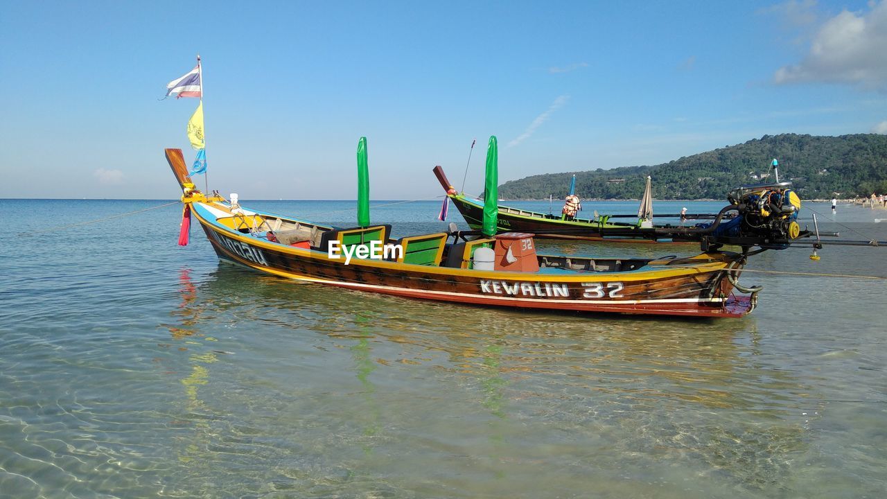 VIEW OF SHIP MOORED ON SEA AGAINST SKY