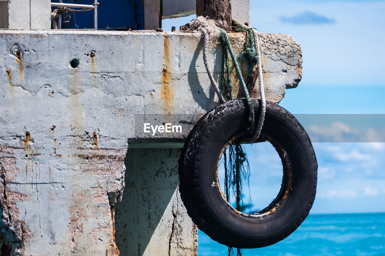 CLOSE-UP OF RUSTY SHIP AGAINST SKY