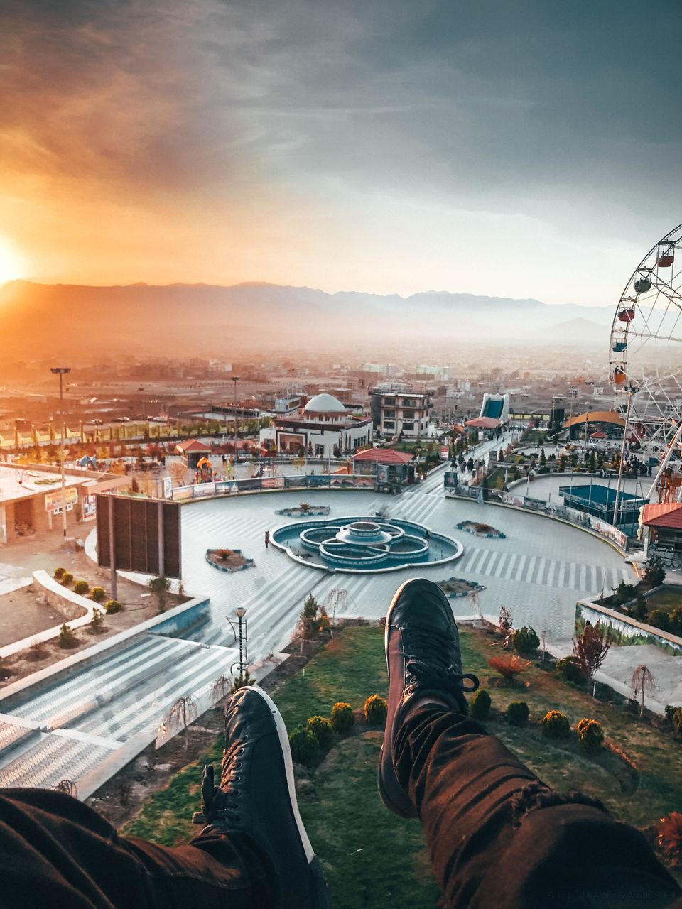 HIGH ANGLE VIEW OF CITYSCAPE AGAINST SKY DURING SUNSET