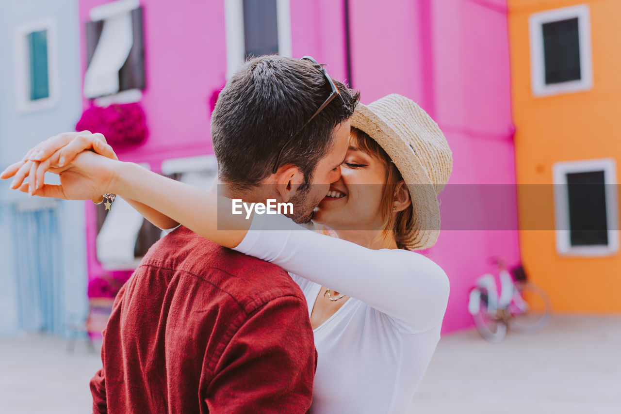 YOUNG COUPLE KISSING WITH HANDS