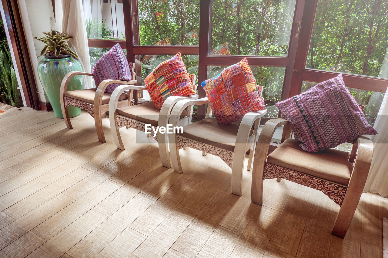 EMPTY CHAIRS AND TABLES IN ROOM