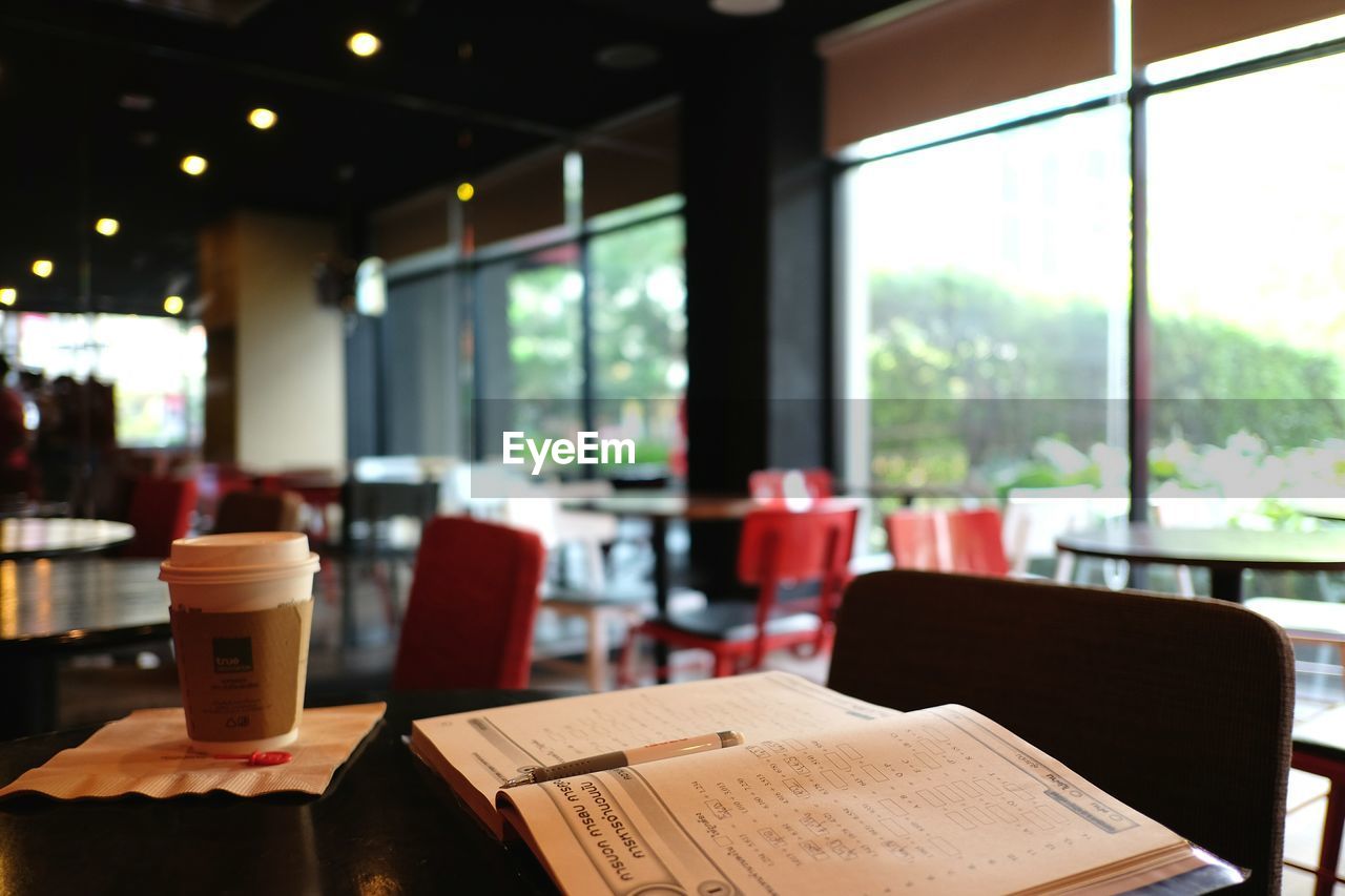 EMPTY CHAIRS AND TABLE IN RESTAURANT