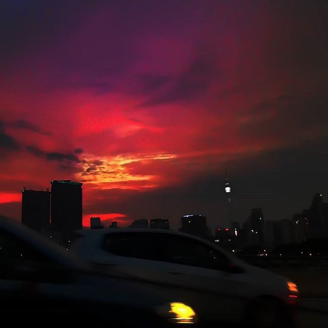 VEHICLES ON ROAD AT SUNSET