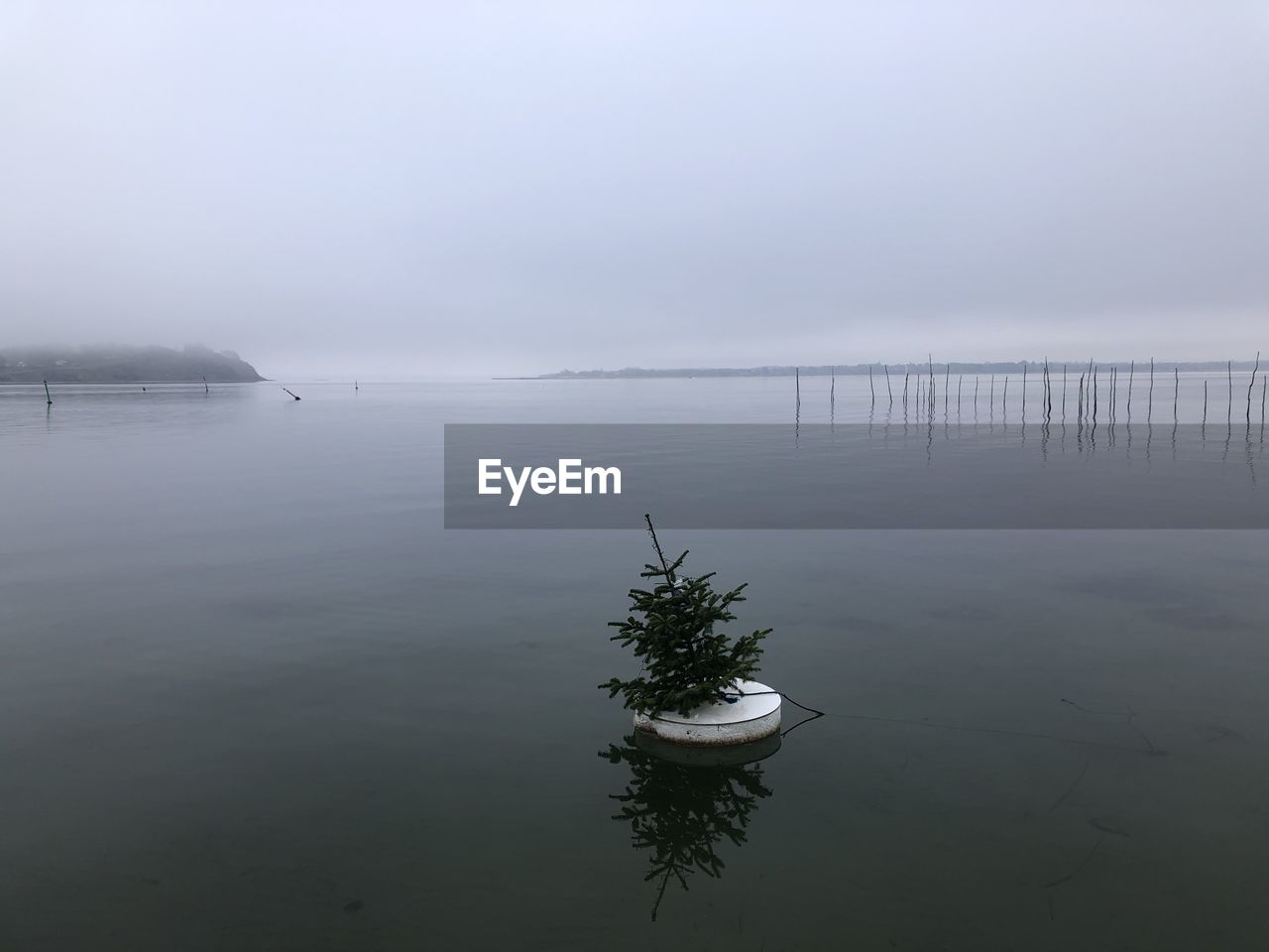 BOAT IN LAKE AGAINST SKY