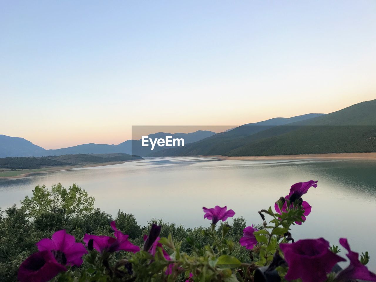 Scenic view of lake against sky during sunset