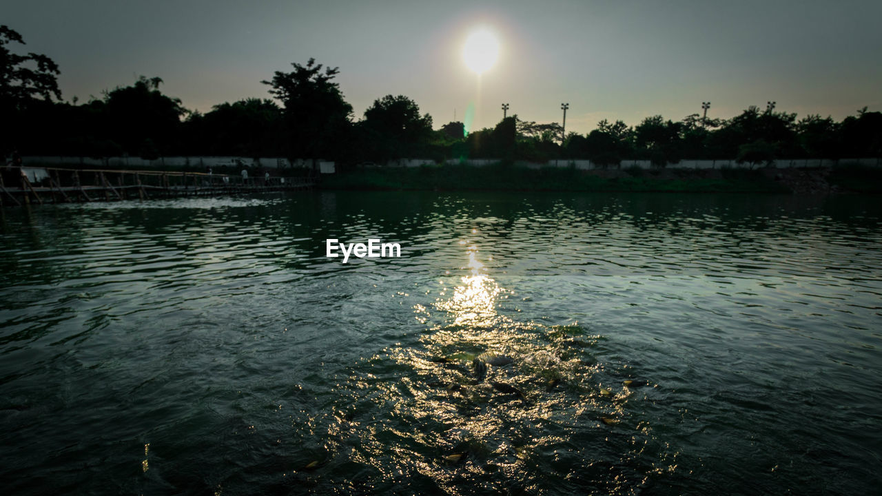 SCENIC VIEW OF SWIMMING POOL AGAINST SKY DURING SUNSET