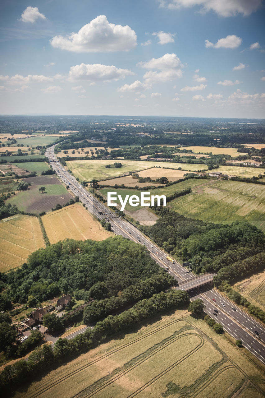 HIGH ANGLE VIEW OF FARMS AGAINST SKY