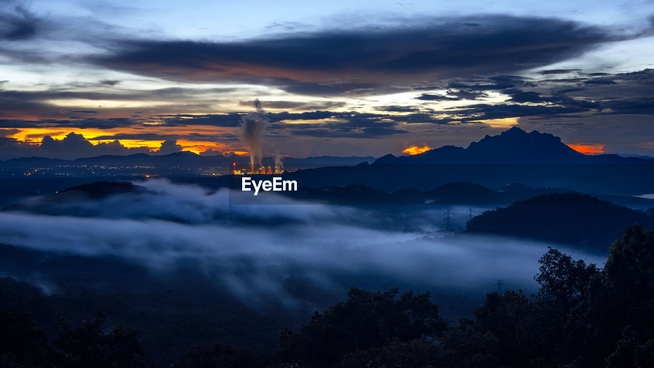 scenic view of mountains against sky at sunset