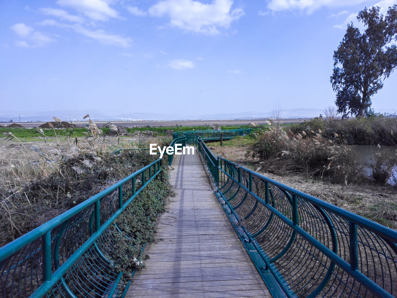 A photo of a wood and steel bridge across the naaman stream in northern israel