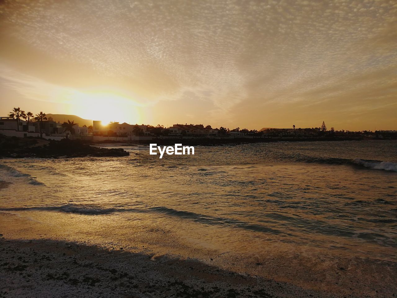 Scenic view of river against sky during sunset