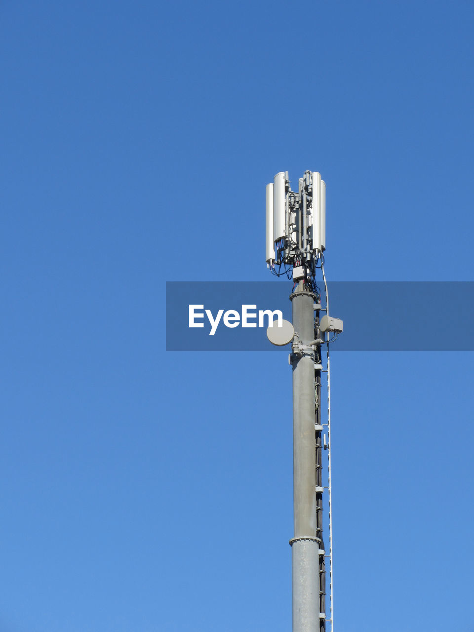 Telephone antenna on blue sky background