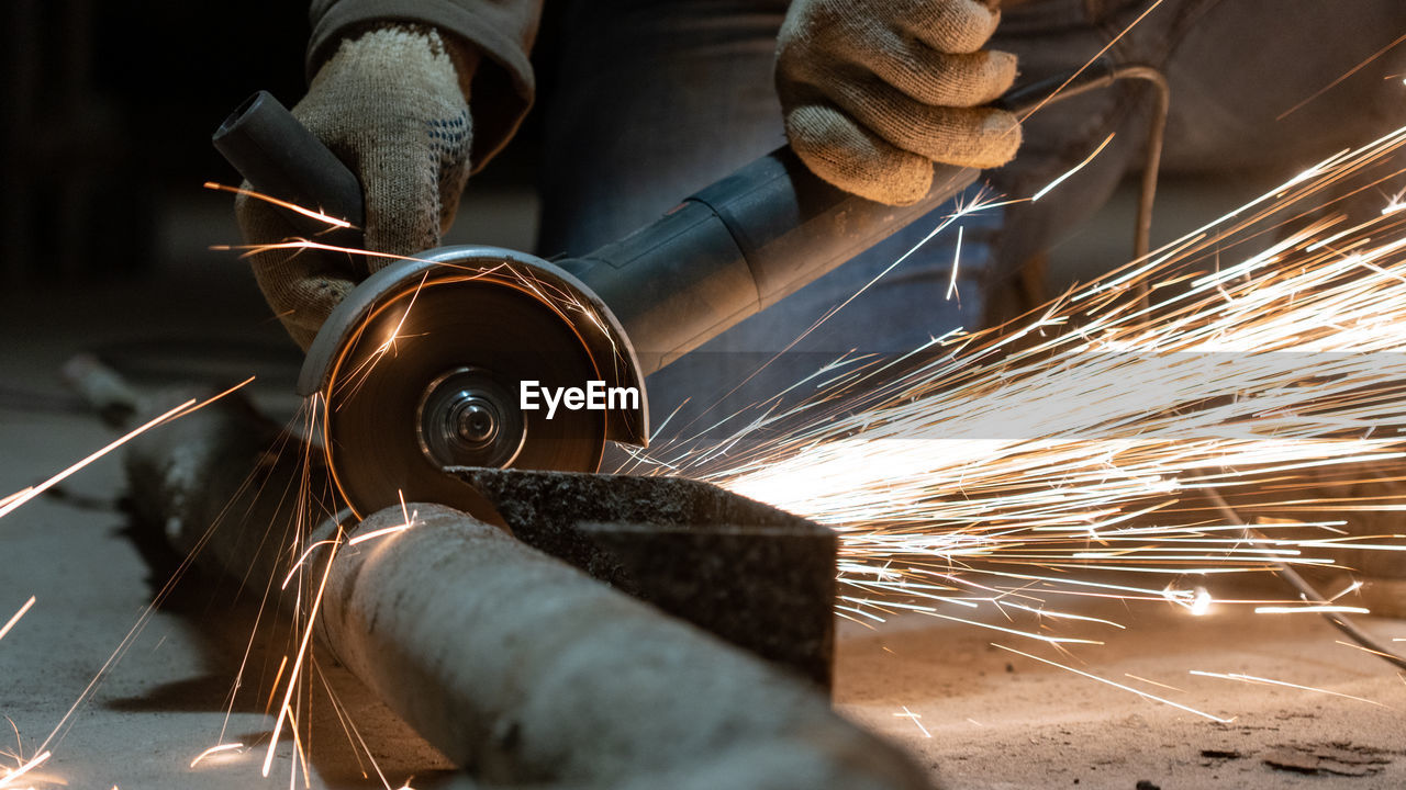 Low angle view of man working on metal