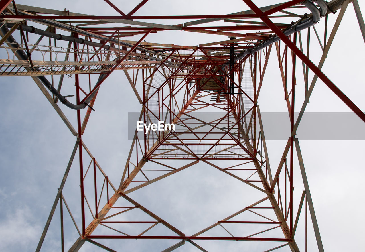 Low angle view of electricity pylon against sky