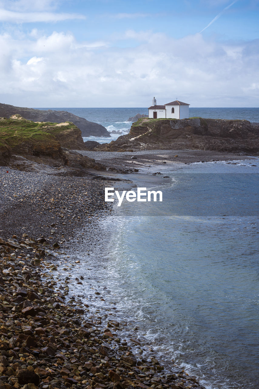 Atlantic ocean. galicia, spain. scenic view of white chapel on top of a rock.virxe do porto ermitage