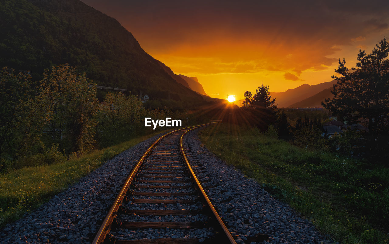 View of railroad tracks against sky during sunset