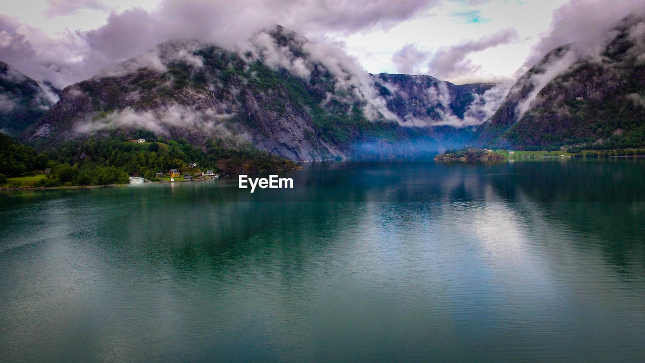 Scenic view of lake and mountains against sky