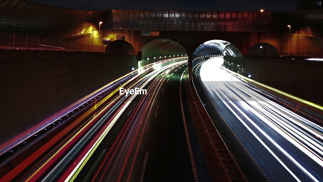 Light trails on road in illuminated tunnel