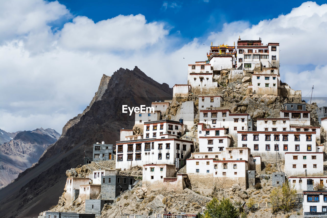 Low angle view of key monastery against cloudy sky