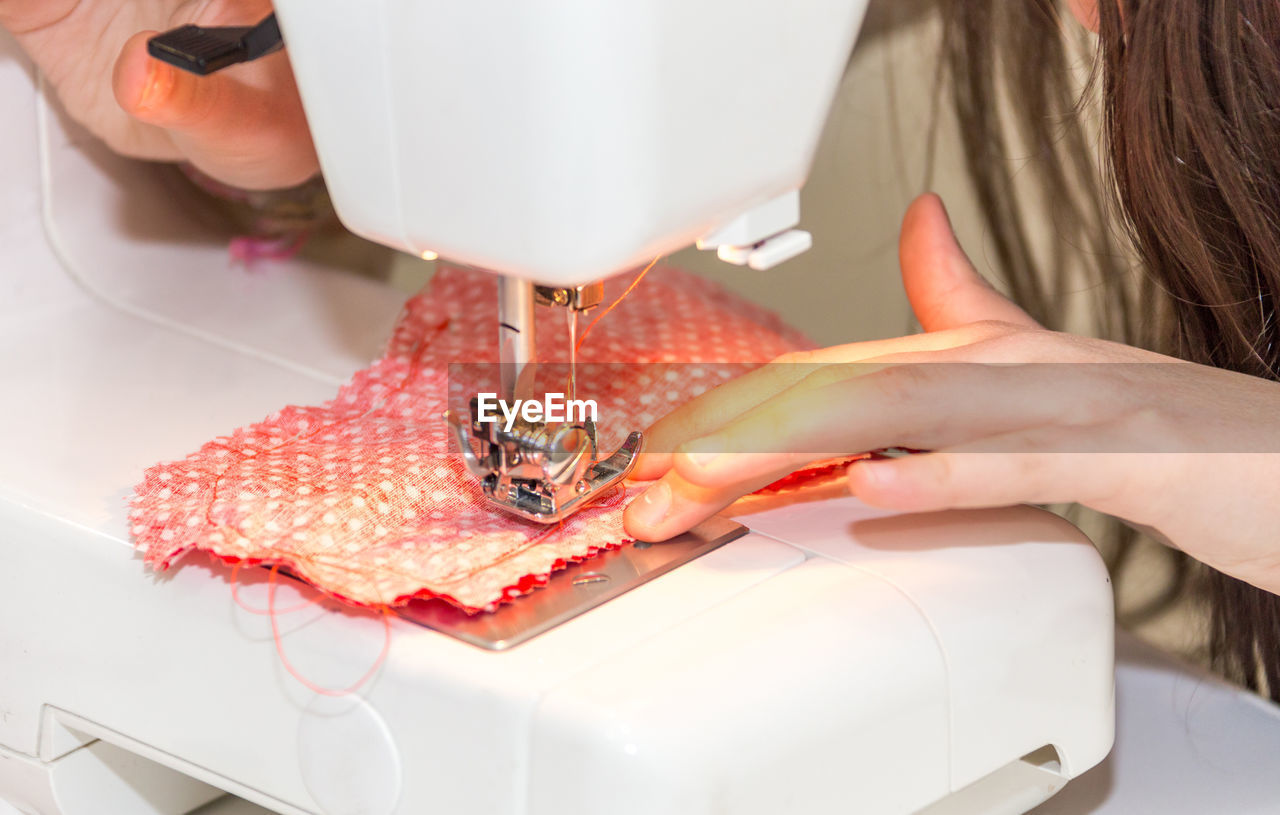 MIDSECTION OF WOMAN WORKING ON TABLE