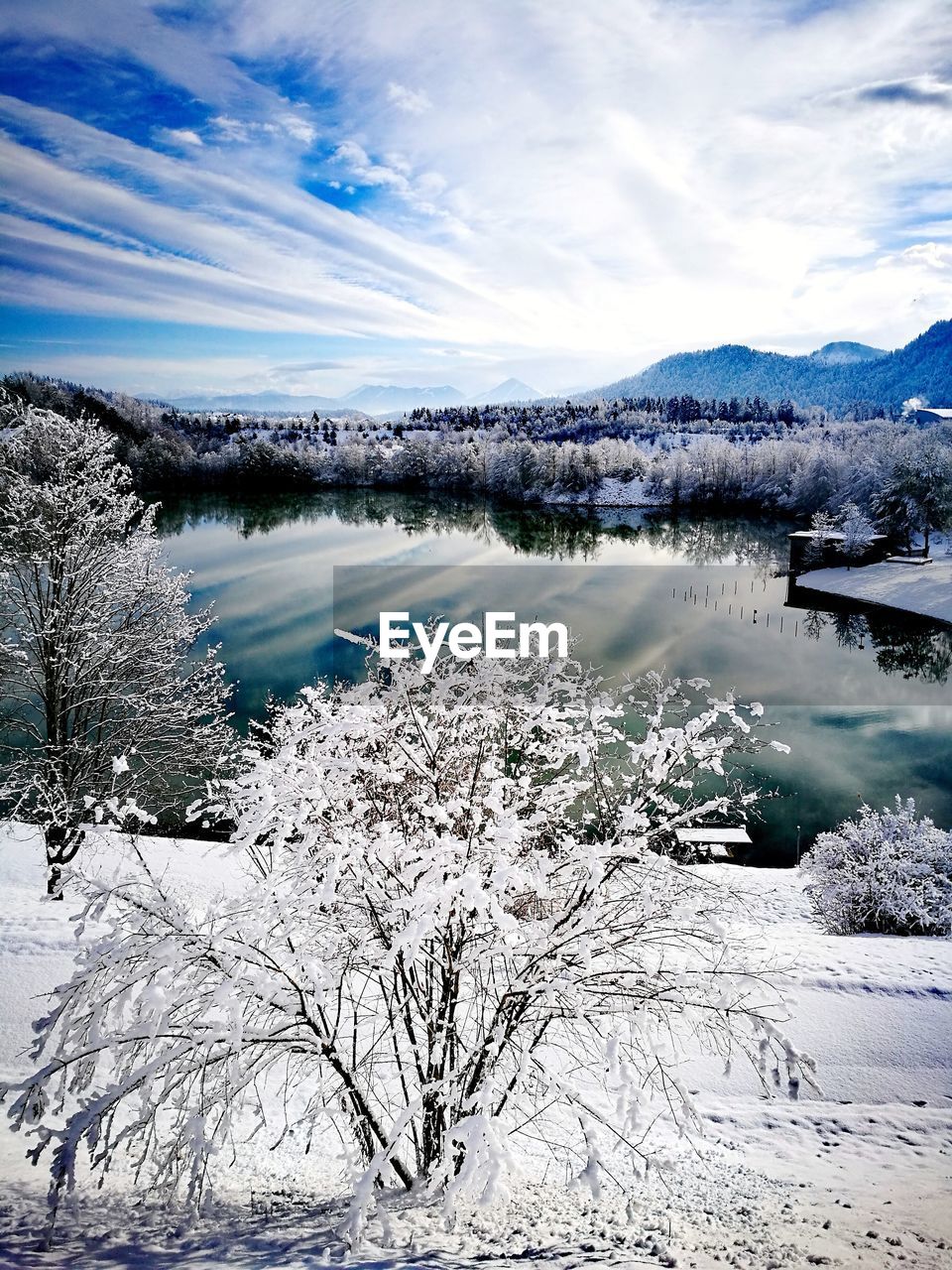 SCENIC VIEW OF LAKE BY SNOW AGAINST SKY